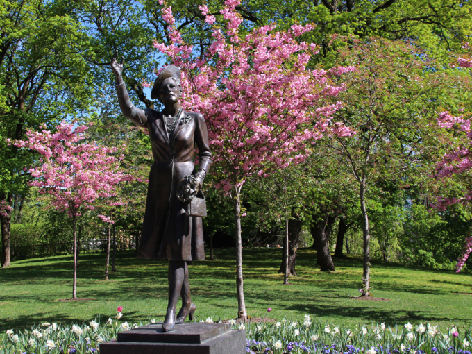 Flowering cherry trees surround the statue and the place is called 